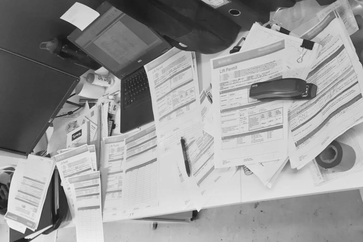 Paperwork stacked on a site desk